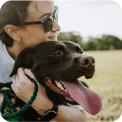 One of our caregivers in Doral at Doggies Gone Wild embracing a dog to provide comfort and build trust, reflecting our commitment to compassionate care.